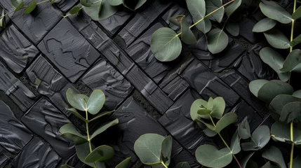 Fotobehang Set against a black herringbone patterned wooden backdrop, eucalyptus sprigs rest, creating a dark, moody botanical scene that exudes an aura of mystery. © Fostor