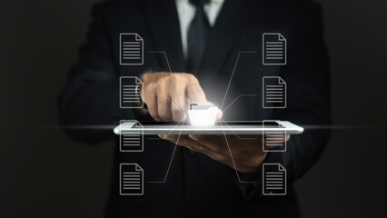 Businessman uses tablet and uses finger on virtual screen to open document folder.