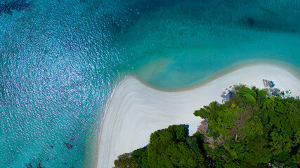 The aerial view of white sand beach tropical with seashore as the island in a coral reef ,blue and...