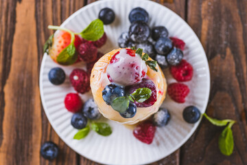 Cheesecakes served with berries and condensed milk