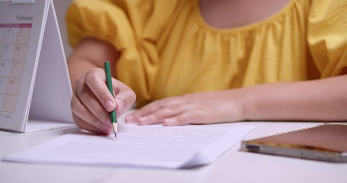 Underlining some of the lines and words in a written article while proofreading and checking for some errors in writing.