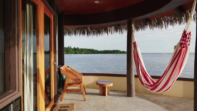 Slow cinematic slider video of luxury overwater bungalow in Fiji looking across the ocean at sunset