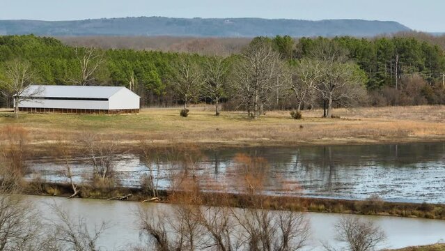 Tranquil scene of Point Remove Wildlife Area, Blackwell, Arkansas with barn, water, and trees