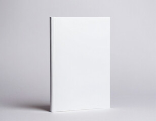 Minimal white book cover standing upright against a neutral gray background, highlighting simplicity and elegance in design.