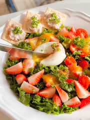 Healthy strawberry kale salad with boiled egg and tuna crackers for breakfast. Morning time. Fresh meal. Delicious food. Homemade food. Cooking recipes. Brunch. Healthy recipes. Vegetable. Clean food.