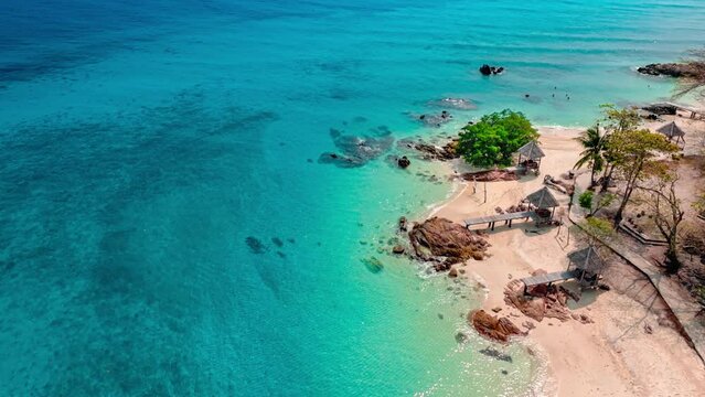 Nature of the beach and sea Summer with sunshine, sandy beaches, clear blue waters sparkling against the blue sky. On an island with good ecology and environment Background for summer vacation