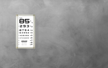 Snellen eye chart in vision clinic isolated on cement background. and text area