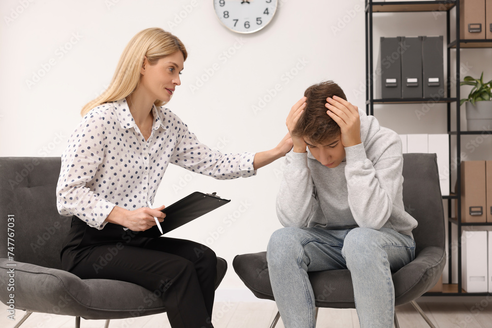 Canvas Prints Psychologist working with teenage boy in office