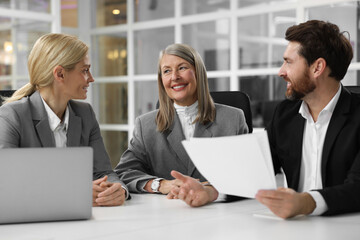 Lawyers working together at table in office