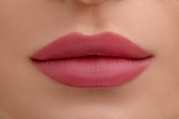 Fototapeta premium Young woman with beautiful full lips as background, closeup