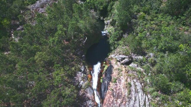 Natural pool of Salto de Aguas Blancas waterfall, Constanza in Dominican Republic. Aerial top-down ascending