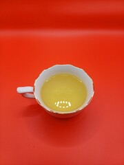 Close-up a cup of tea on red background.