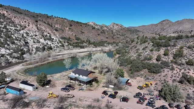 Aerial rural farm house mountain valley river pond Utah 1. Motoqua is an old historic settlement and a past Vegas gangster retreat. Ghost town. Historic pioneers. Rural community farming agriculture.