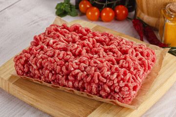 Raw minced beef meat over board