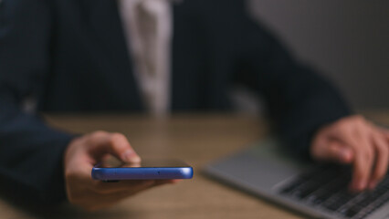 Businessmen use smartphones in offices with copy space for putting text, icons, and logo concepts for banners, wallpaper, backgrounds, and ideas. selective focus on smartphones.