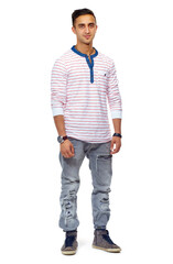Fototapeta premium Portrait, man or confidence for fashion, style or clothes in casual outfit on studio background in edgy apparel, wardrobe or trendy. Male person, model or face in ripped jeans, sneakers or chic