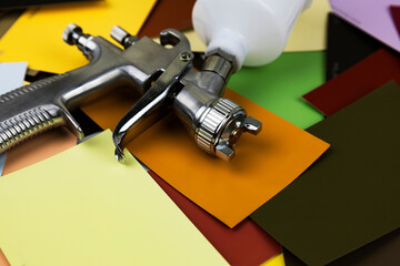 paint spray gun at work at the workplace in the workshop.
