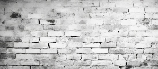 A black and white brick wall with abstract patterns created by large white bricks, providing a textured background with copy space for design projects.
