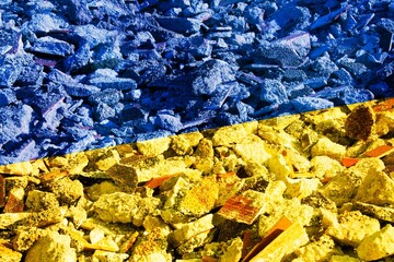 Ukraine flag with a destroyed building as background. Concept image for the Russian attack on...