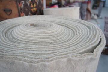 A large roll of felt. Fabric for the yurt, the traditional dwelling of the nomads.