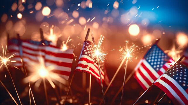 Bright burning sparklers against American flag, closeup