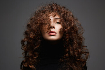 beautiful young woman with curly hair. healthy hair girl