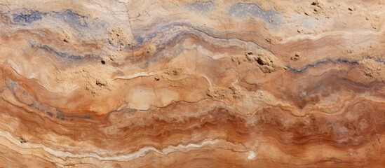 Fototapeta premium A close-up view of a brown and black marble surface, showcasing intricate patterns and textures. The marbles are rich in color, with a mix of brown and black tones creating a striking contrast.