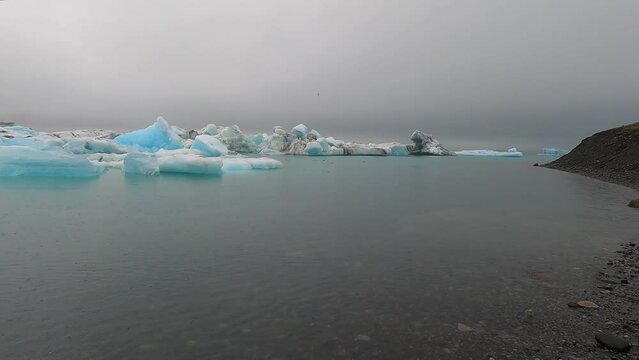 Jokulsarlon glacial lagoon in Iceland, with luminous blue icebergs.