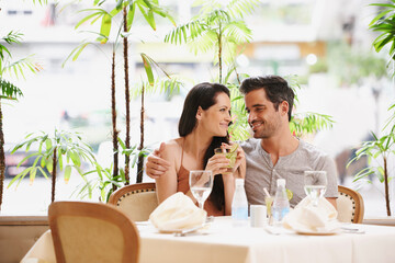 Couple, restaurant and drinks with lunch, love and romance for anniversary or celebration. Woman,...