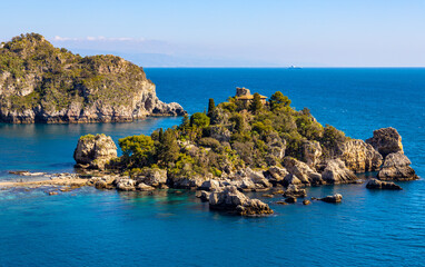 Panoramic view of Capo Taormina cape with Isola Bella island on Ionian sea shore in Messina region of Sicily in Italy - obrazy, fototapety, plakaty