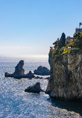 Rocks and cliffs of Capo Taormina cape on Ionian sea shore of Taormina, Giardini Naxos and...