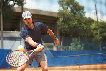 Fitness, sports or tennis and man with racket hitting ball on court for competition, game or match....