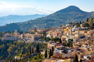 Taormina panorama with Castello Saraceno Saracen Castle on Monte Tauro rock over Ionian sea and Etna volcano in Messina region of Sicily in Italy