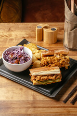 sandwiches and potatoes on the table in the bar