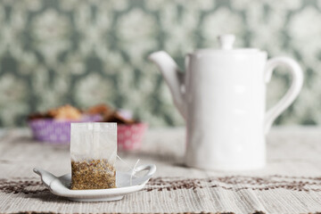 Tea bag ready for brewing on a plate