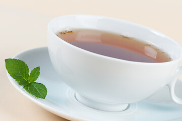 Close-up of tea with mint on saucer