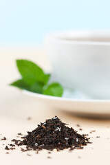 Focus on loose leaf tea with cup