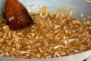 thin coconut flakes fried in sugar syrup , sweet orange and yellow coconut flakes fried in sugar