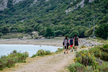 Fototapeta na wymiar hikers walking on the road, Cúber reservoir, Escorca, Mallorca, Balearic Islands, Spain