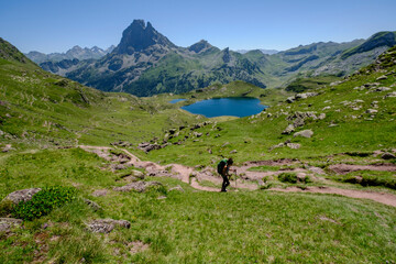 Fototapeta na wymiar hiker on Lac Gentau, Ayous lakes tour, Pyrenees National Park, Pyrenees Atlantiques, France
