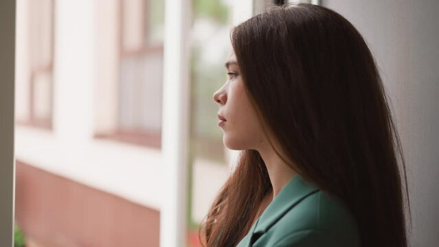 Woman eyes linger on steady rainfall outside. Businesswoman feels grip of hopelessness tightening around suffocating any semblance of optimism