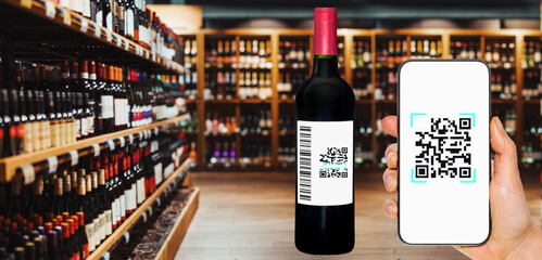 Scanning E-label concept for alcohol production and selling industry. Scanning unreal qr and bar code on label of wine bottle by smart phone in hand.