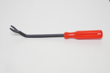rivet screwdriver made of black iron with a red plastic handle from the side angle on a white...