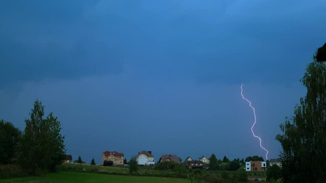 Lightning bolt. Evening thunderstorm in rural place. Twilight dark blue sky. Cyclone. Bad weather. Concept of fresh ozon air after hot. Brontophobia. A natural phenomenon. Slow motion. 4K
