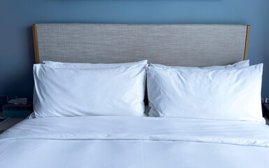 white pillows on the bedroom on a bed with duvet case bedspread isolated on white background