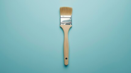 **Image description:**  A paintbrush with a wooden handle and silver ferrule on a blue background. The brush is clean and new.
