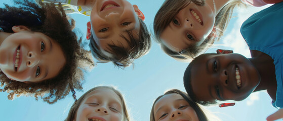 Cheerful group of diverse children looking down into the camera, beaming smiles.