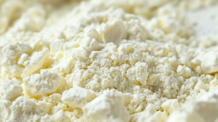 Close-up of a pile of white cottage cheese. The cheese is in small curds and has a creamy texture.