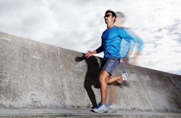 Motion blur, workout and athlete running on road for energy, exercise and practice for marathon in city. Mock up, male person and runner in street for cardio of speed for sports and wellness