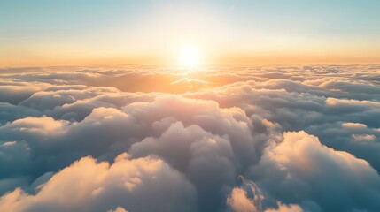 Amazing view of the clouds from above. The setting sun casts a golden glow on the clouds. - obrazy, fototapety, plakaty